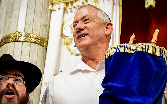 Blue and White party leader Benny Gantz carries a Torah scroll as he dances during Simchat Torah celebrations in the central Israeli village of Kfar Chabad, October 21, 2019. (Yossi Zeliger/Flash90)