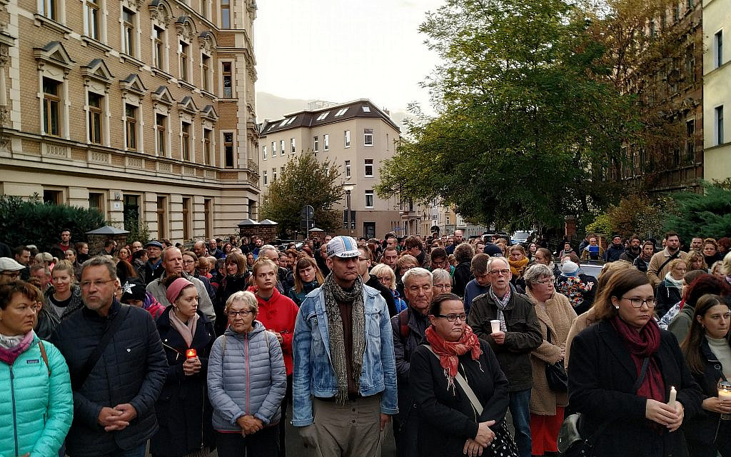 People gather in candle light vigil in front of the synagogue in Halle, Germany, October 11, 2019. (Yaakov Schwartz/ Times of Israel)