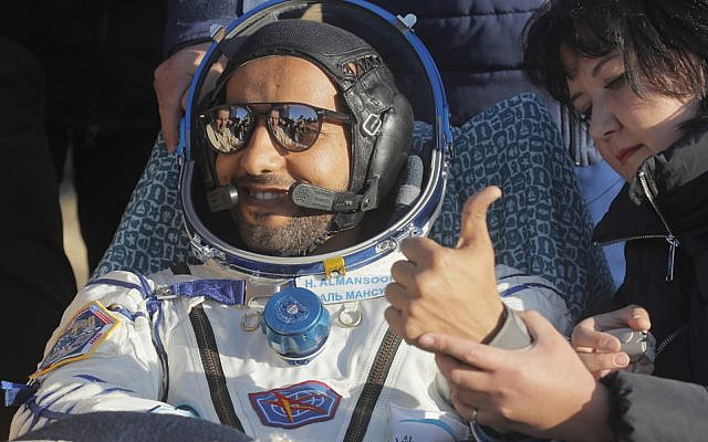 United Arab Emirates astronaut Hazzaa al-Mansoori gestures shortly after the landing in a space capsule about 150 km (90 miles) south-east of the Kazakh town of Dzhezkazgan, on October 3, 2019. (Dmitri Lovetsky/Pool/AFP)