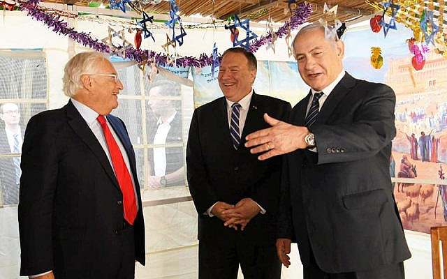 US Secretary of State Mike Pompeo  (center) visits the prime minister's holiday sukkah, during talks with Prime Minister Benjamin Netanyahu on October 18, 2019. At left is US Ambassador to Israel David Friedman. (Amos Ben Gershom/GPO)