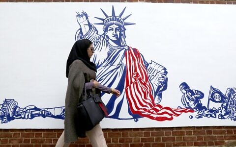 An Iranian woman walks past a new mural painted on the walls of the former US embassy in the capital Tehran on November 2, 2019. (Atta Kenare/AFP)