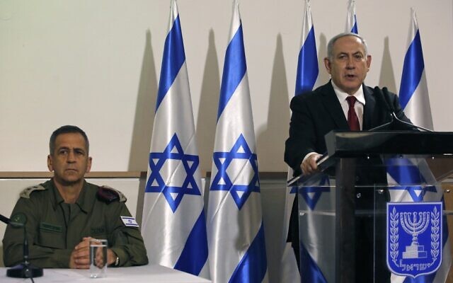 Prime Minister Benjamin Netanyahu (right) and IDF Chief of Staff Aviv Kohavi during a press conference at the Defense Ministry in Tel Aviv on November 12, 2019 (GIL COHEN-MAGEN / AFP)