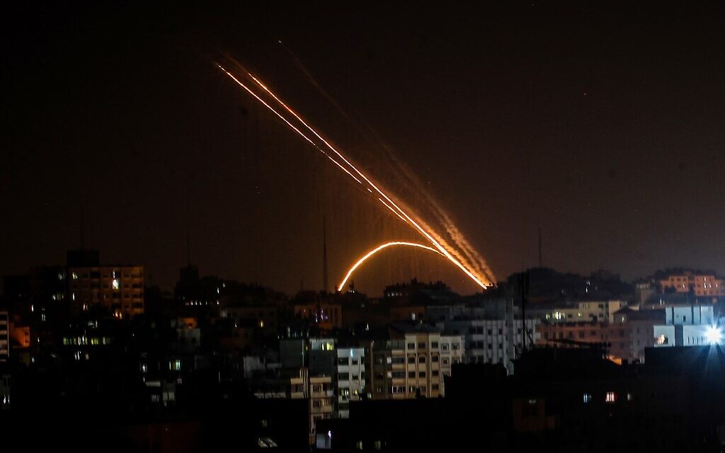 Illustrative: Rockets are fired from the Gaza Strip toward Israel, on November 13, 2019. (Anas Baba/AFP)