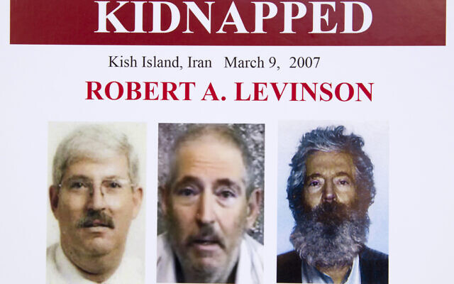 In this March 6, 2012, file photo, an FBI poster showing a composite image of former FBI agent Robert Levinson, right, of how he would look like now after five years in captivity, and an image, center, taken from the video, released by his kidnappers, and a picture before he was kidnapped, left, displayed during a news conference in Washington. (AP Photo/Manuel Balce Ceneta)