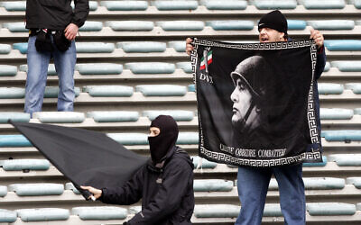 Italian soccer fans hold black flags effigying late dictator Benito Mussolini, during an Italian major league soccer match in Rome in 2006. (AP Photo/Plinio Lepri)