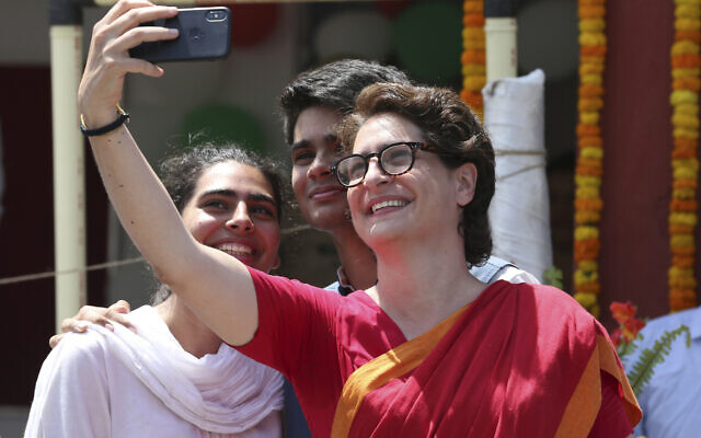 Congress party General secretary Priyanka Vadra in red, takes selfie with her children after her brother Congress president Rahul Gandhi filed his nomination papers for the upcoming general elections in Amethi, Uttar Pradesh state, India, April 10, 2019.  (AP Photo/Rajesh Kumar Singh)