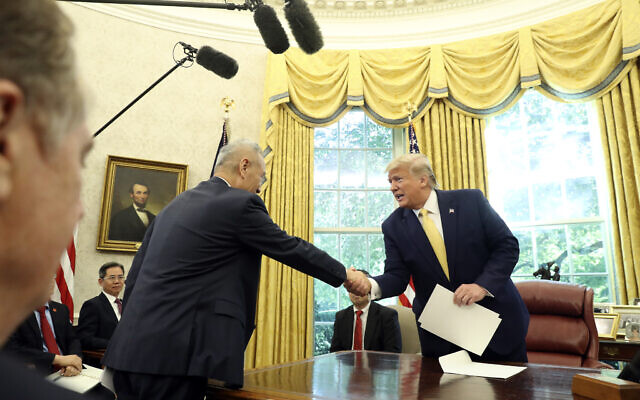 President Donald Trump shakes hands with Vice Premier Liu He in the Oval Office of the White House in Washington, Friday, Oct. 11, 2019. (AP Photo/Andrew Harnik)
