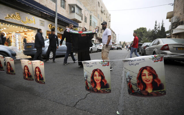 Palestinians hang photos of Heba al-Labadi, a Jordanian citizen of Palestinian descent, during a protest demanding her release in East Jerusalem on Oct. 26, 2019. (AP/Mahmoud Illean)