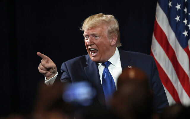US President Donald Trump gestures to an audience member after speaking at his Black Voices for Trump rally, November 8, 2019, in Atlanta. (AP Photo/John Bazemore)