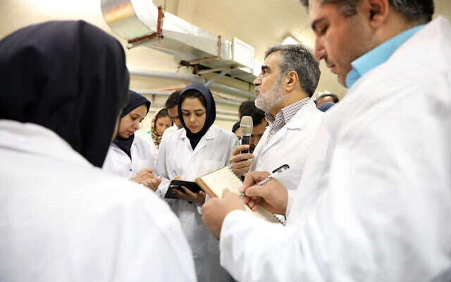 In this photo released by the Atomic Energy Organization of Iran, spokesman of the organization Behrouz Kamalvandi, center, briefs the media while visiting Fordo nuclear site near Qom, south of Tehran, Iran, November 9, 2019 (Atomic Energy Organization of Iran via AP)