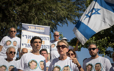 Bereaved parents of Hadar Goldin and other family members and supporters gather outside the state memorial ceremony for Operation Protective Edge at Mount Herzl on July 23, 2019. (Noam Revkin Fenton/Flash90)