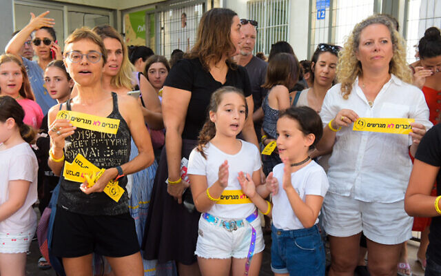 Illustrative: Israeli school kids, Filipino workers, and their children take part at a protest against deportation of children's of Filipino workers on the first day of school, outside the Balfour School in Tel Aviv, on September 1, 2019. (Avshalom Shoshoni/Flash90)