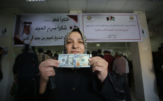 Palestinians receive financial aid from Qatar at a post office in Gaza City, November 27, 2019. (Hassan Jedi/Flash90)