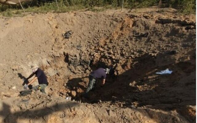 Israelis inspect a crater left by a new Islamic Jihad rocket in southern Israel in November 2019 (Screencapture/Channel 12)