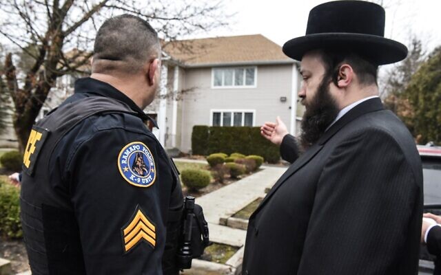 A member of the Ramapo police stands guard in front of the house of Rabbi Chaim Rottenberg on December 29, 2019, in Monsey, New York. (Stephanie Keith/Getty Images/AFP)