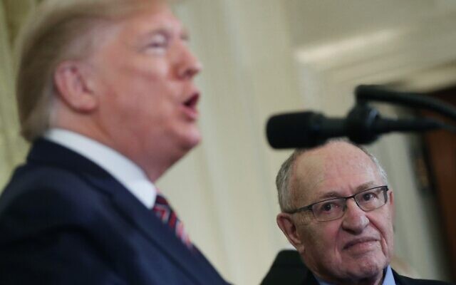 Law Professor Alan Dershowitz, right, listens to US President Donald Trump speak during a Hanukkah Reception in the East Room of the White House in Washington, DC, December 11, 2019.   (Mark Wilson/Getty Images/AFP)