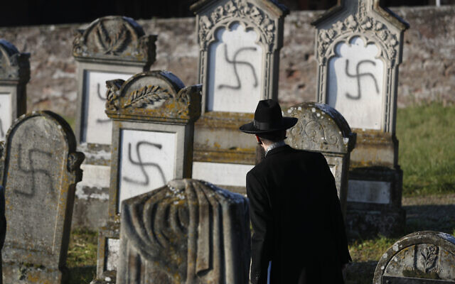 Strasbourg chief Rabbi Harold Abraham Weill looks at vandalized tombs in the Jewish cemetery of Westhoffen, west of the city of Strasbourg, eastern France, December 4, 2019. (Jean-Francois Badias/AP)