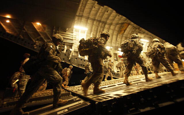Illustrative: US Army soldiers from 2nd Brigade, 10th Mountain Division board a C-17 aircraft at Baghdad International Airport as they begin their journey to the United States, on July 13, 2010. (Maya Alleruzzo/ AP/ File)