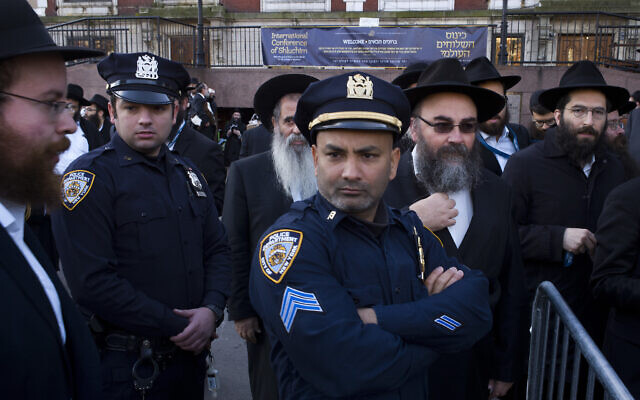 Illustrative: New York City police officers watch as rabbis gather for a group photo at the Chabad-Lubavitch World Headquarters,Sunday, Nov. 4, 2018, in New York. More than 5,000 of the orthodox Jewish leaders from around the world are taking part in the annual meeting.  (AP Photo/Mark Lennihan)