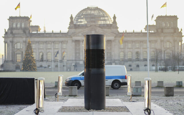 An oversized urn covered with a black plastic wrap placed by the artist group Center for Political Beauty in front of German parliament building, the Reichstag in Berlin, Germany, December 5, 2019. (AP Photo/Markus Schreiber)