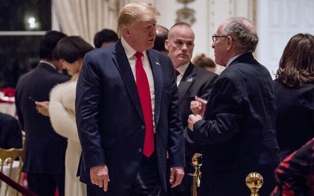 President Donald Trump speaks to attorney Alan Dershowitz, right, as he arrives for Christmas Eve dinner at Mar-a-lago in Palm Beach, Fla., Tuesday, December 24, 2019. (AP Photo/Andrew Harnik)