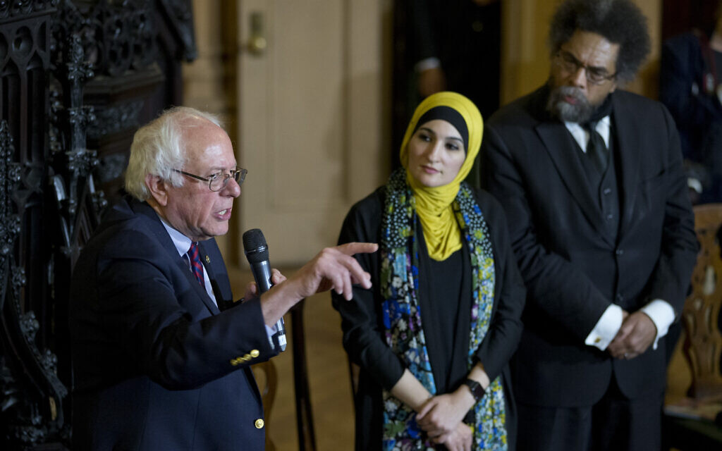 Linda Sarsour, center and Cornel West, right, listen as Democratic presidential candidate Bernie Sanders, I-Vt., speaks in a roundtable discussion at the First Unitarian Congregational Society, Saturday, April 16, 2016, in the Brooklyn borough of New York. (AP Photo/Mary Altaffer)