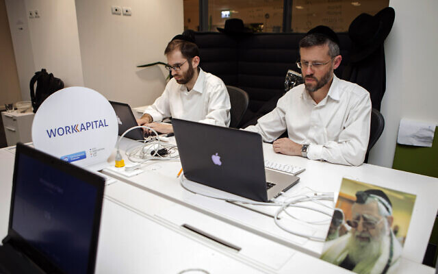 Ultra-Orthodox Jewish men work at a high tech start-up in an office in Tel Aviv, on March 15, 2016. (AP Photo/Dan Balilty)