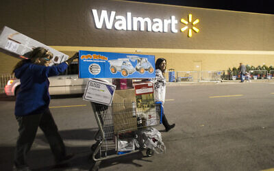 Holiday shoppers leaves Walmart's Black Friday event in Bentonville, Arkansas, on November 24, 2016. (Gunnar Rathbun/AP Images for Walmart)