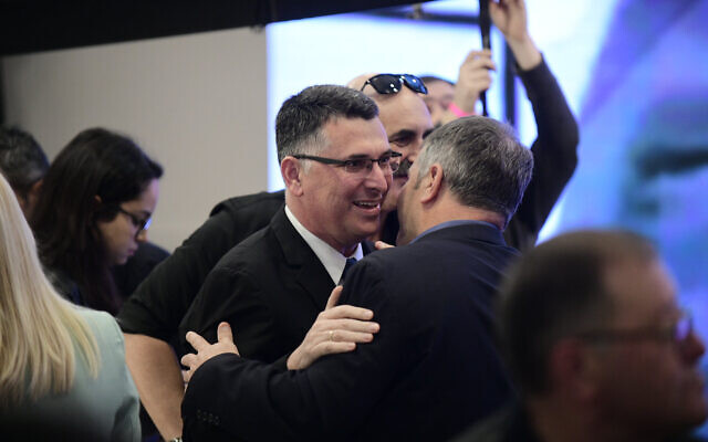 Likud MK Gideon Saar (L) embracing MK Yoav Kisch at a party conference in Ramat Gan, March 4, 2019. (Tomer Neuberg/Flash90)