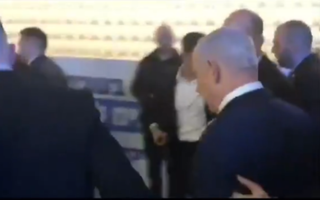 Prime Minister Benjamin Netanyahu is taken offstage during a Likud primary campaign event in Ashkelon as rocket alerts sound, December 25, 2019. (Screenshot: Twitter)
