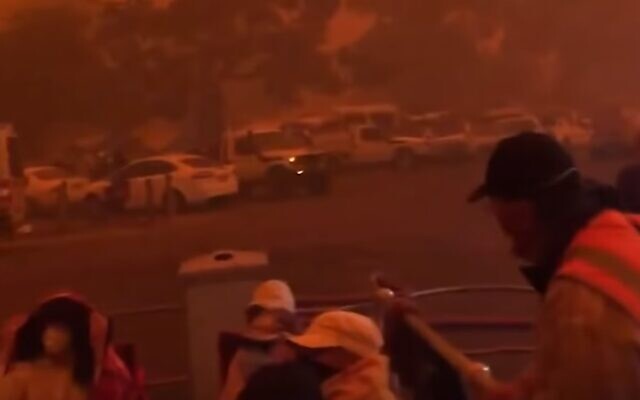 People preparing to evacuate as fires hem in the city of Mallacoota, Victoria, Australia. (screen capture: YouTube)