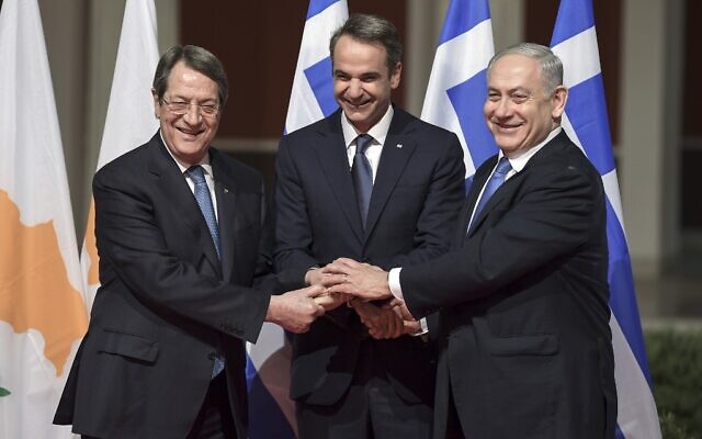 Former prime minister Benjamin Netanyahu (R), his Greek counterpart Kyriakos Mitsotakis (C) and Cypriot President Nikos Anastasiadis shake hands in Athens on January 2, 2020, ahead of the signing of an agreement for the EastMed pipeline project designed to ship gas from the eastern Mediterranean to Europe. (Aris Messins/AFP)