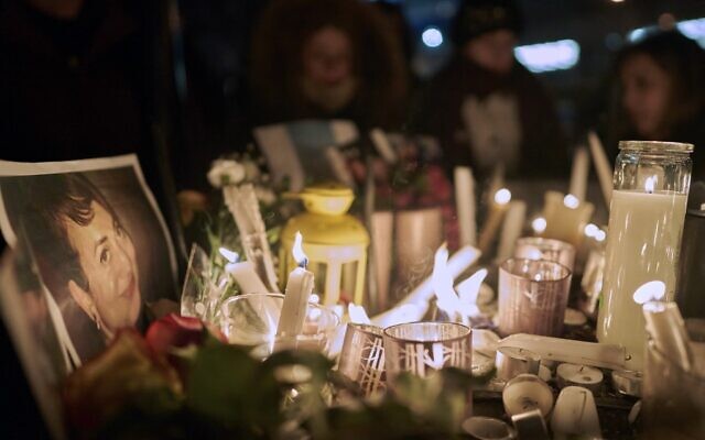 Candles light up a photo of one of the victims of Ukrainian Airlines flight 752 which crashed in Iran earlier, during a vigil at Mel Lastman Square in Toronto, Ontario on January 9, 2020. (Geoff Robins / AFP)