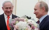 Russian President Vladimir Putin (right) with a bouquet of flowers and Prime Minister Benjamin Netanyahu at the Kremlin in Moscow on January 30, 2020. (Maxim Shemetov/Pool/AFP)