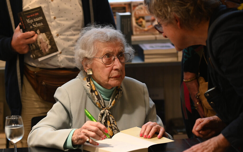 Selma van de Perre signs her book at the National Holocaust Museum in Amsterdam, January 9, 2020. (Cnaan Liphshiz/JTA)