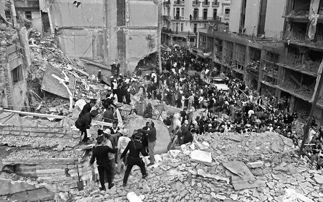 Firemen and policemen search for wounded people after a bomb exploded at the Argentinian Israelite Mutual Association (AMIA in Spanish) in Buenos Aires, 18 July 1994. (ALI BURAFI/AFP/Getty Images via JTA)