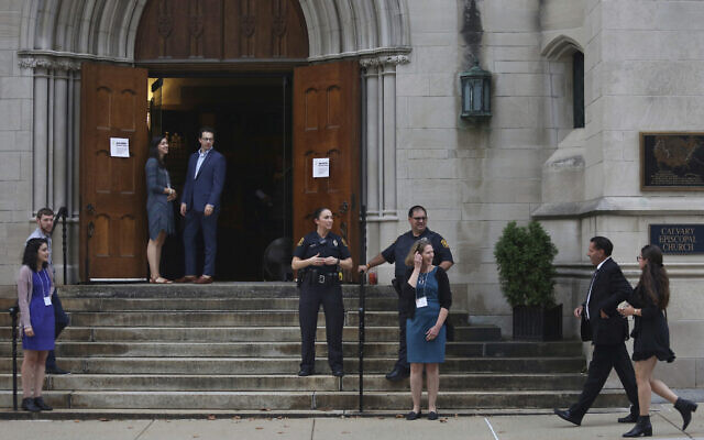 In this September 29, 2019 file photo, members of the Jewish community arrive for services as Pittsburgh Police Detectives provide security on the first night of Rosh Hashana at Calvary Episcopal Church in Pittsburgh. (Rebecca Droke via AP)
