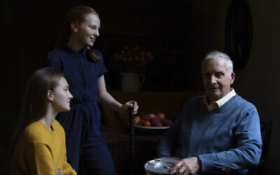 In this photo taken by Britain's Kate, Duchess of Cambridge, and made available on January 26, 2020, Steven Frank BEM, aged 84, originally from Amsterdam, who survived multiple concentration camps as a child, is pictured alongside his granddaughters Maggie and Trixie Fleet, aged 15 and 13. (The Duchess of Cambridge via AP)