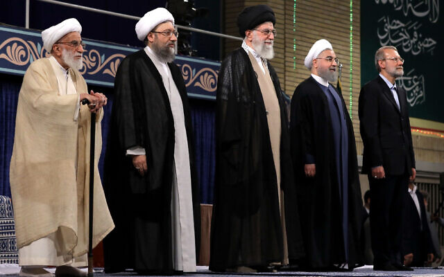 In this picture released by official website of the office of the Iranian supreme leader, Supreme Leader Ayatollah Ali Khamenei, center, President Hassan Rouhani, second right, parliament speaker Ali Larijani, right, judiciary chief Sadeq Larijani, second left, and head of the Assembly of Experts and secretary of Guardian Council Ahmad Jannati listen to the national anthem at the start of the official endorsement ceremony of President Rouhani in Tehran, Iran, August 3, 2017. (Office of the Iranian Supreme Leader via AP)