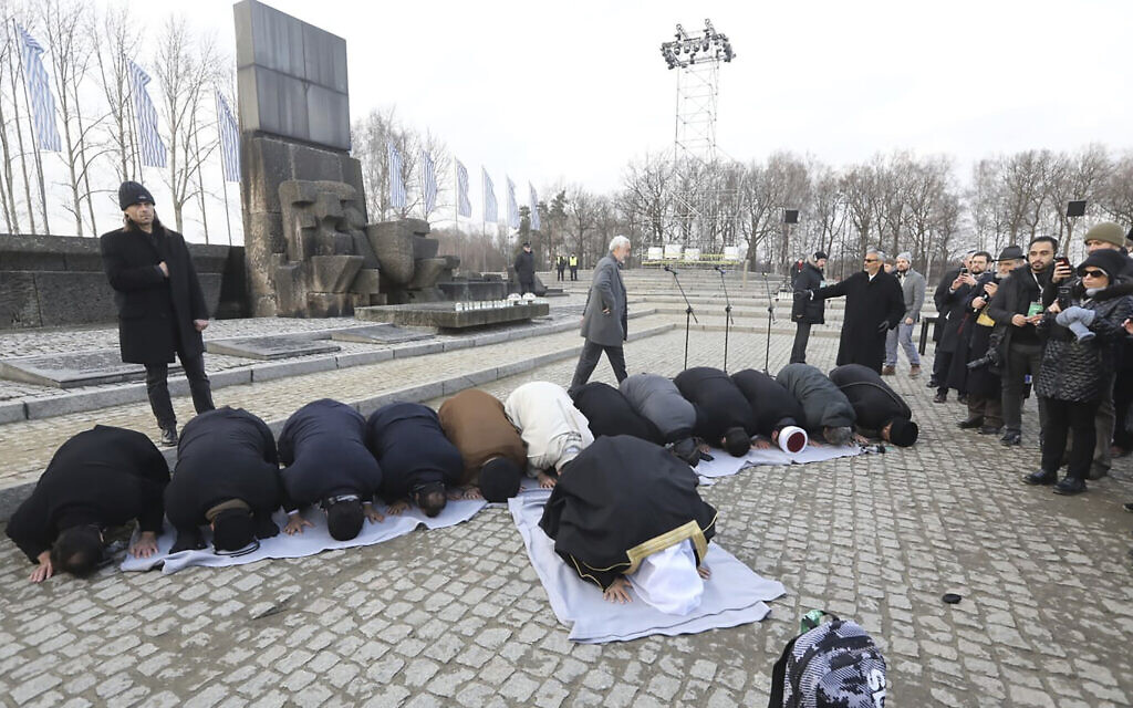 A delegation of Muslim religious leaders perform prayers during a visit to the former Nazi death camp of Auschwitz,  in what organizers called “the most senior Islamic leadership delegation" to visit, in Oswiecim, Poland, January 23, 2020. (American Jewish Committee via AP)