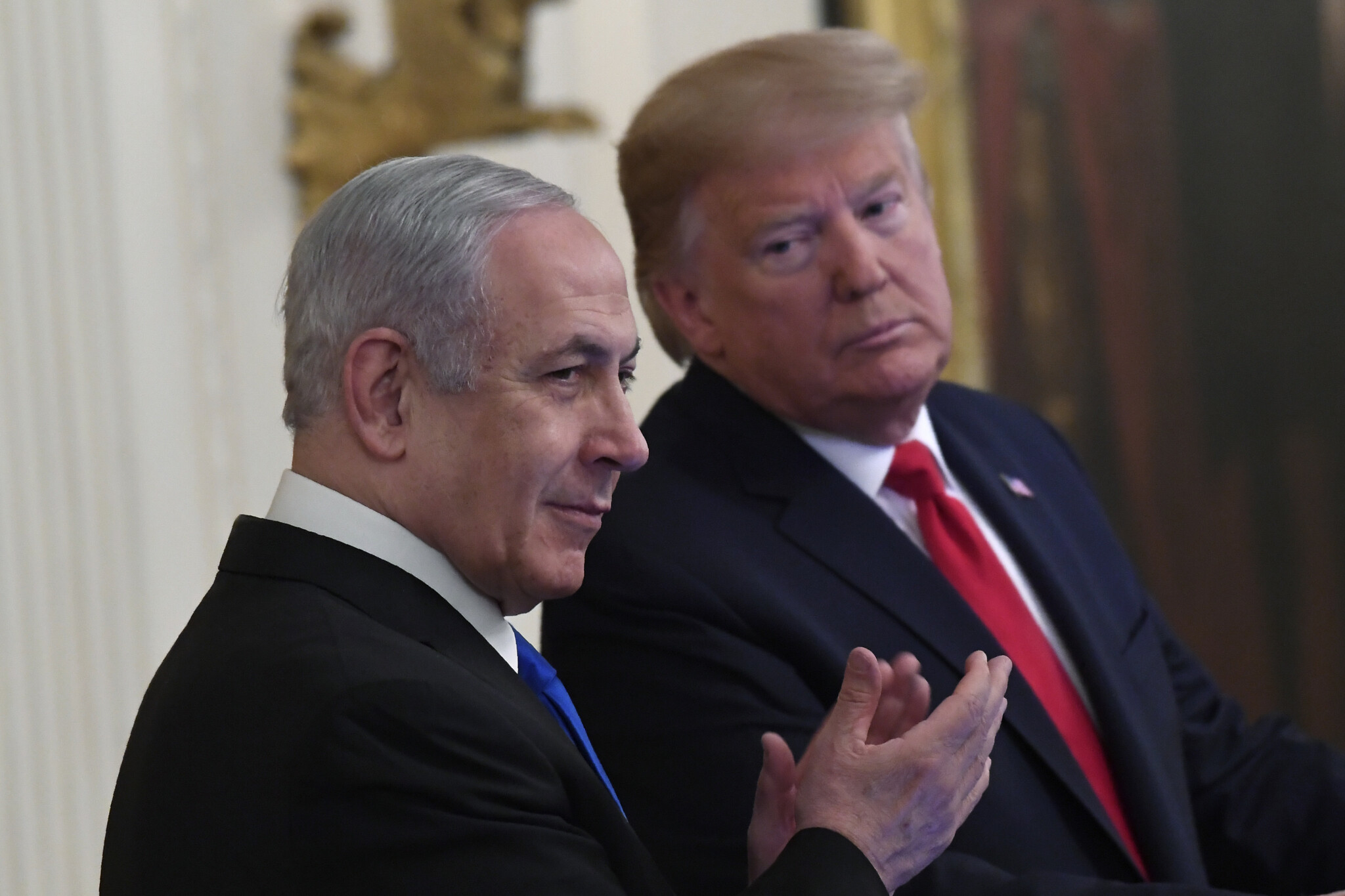 US President Donald Trump, right, looks over to Prime Minister Benjamin Netanyahu, left, during an event in the East Room of the White House in Washington, January 28, 2020. (AP/Susan Walsh)