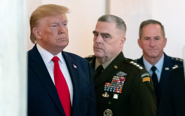 US President Donald Trump arrives to address the nation from the White House on the ballistic missile strike that Iran launched against Iraqi air bases housing US troops accompanied by Joint Chiefs Chairman Gen. Mark Milley, center, and US Air Force Chief of Staff Gen. David L. Goldfein, January 8, 2020. (AP Photo/Alex Brandon)