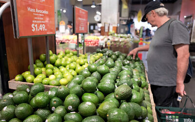 Illustrative: A man shops for avocados at a Whole Foods Market in New York, August 28, 2017. (AP/Mark Lennihan)