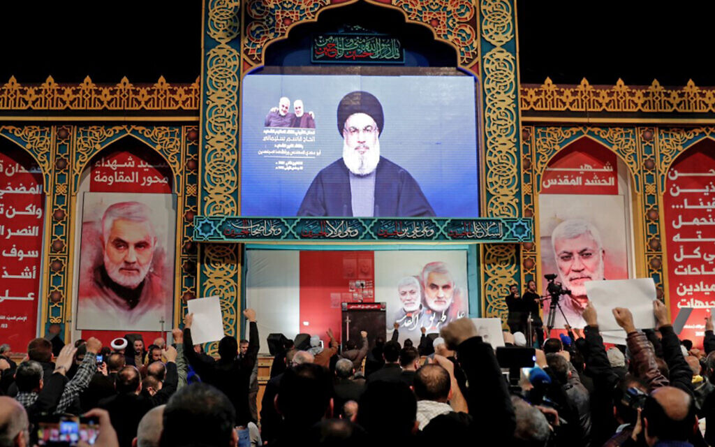 Supporters of Shiite Hezbollah terror group watch a speech by its leader Hasan Nasrallah, broadcast on a screen, in the Lebanese capital Beirut’s southern suburbs, January 5, 2020. (Anwar Amro/AFP)