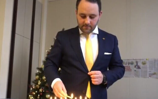 Lawmaker Michael Freilich lights Hanukkah candles in the Belgian Federal Parliament in Brussels, Belgium, December 19, 2019. (Michael Freilich)