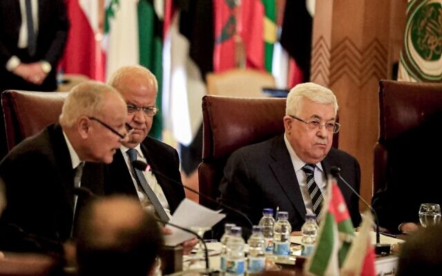 Palestinian Authority President  Mahmoud Abbas (R) and Palestine Liberation Organization Secretary General Saeb Erekat (C) look on as Arab League Secretary General Ahmed Aboul Gheit (L) reads a statement during an Arab League emergency meeting discussing the US-brokered proposal for a settlement of the Middle East conflict, at the league headquarters in the Egyptian capital Cairo on February 1, 2020. (Khaled Desouki/AFP)