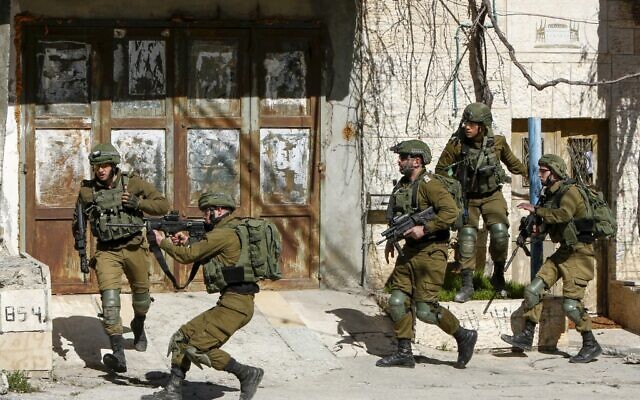 Israeli soldiers clash with Palestinians during a manhunt for a Palestinian man who rammed his car into IDF troops earlier in the day, in Bethlehem on February 6, 2020. (Musa Al Shaer/AFP)