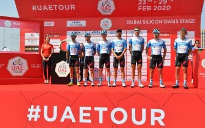 Israel Start-Up Nation cycling team members pose before the start of the first stage of the UAE Tour from the Pointe to Silicon Oasis in Dubai on February 23, 2020. (Photo by Giuseppe CACACE / AFP)