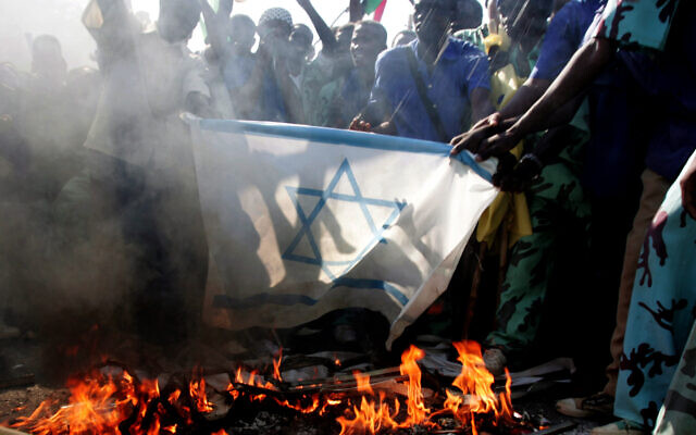 Sudanese students burn an Israeli flag as they demonstrate against the Israeli airstrikes in Gaza outside the UN headquarters in Khartoum, Sudan, December 29, 2008.(AP/Abd Raouf)