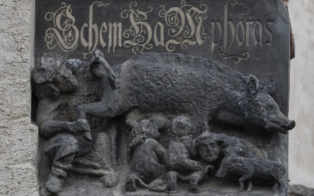 In this photo from January 14, 2020, the so-called "Judensau," or "Jew pig," sculpture is displayed on the facade of the Stadtkirche (Town Church) in Wittenberg, Germany. (AP Photo/Jens Meyer, File )